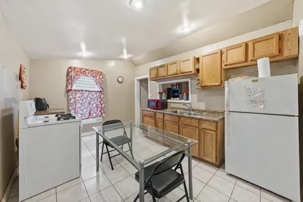 a kitchen with stainless steel appliances a refrigerator and a stove top oven