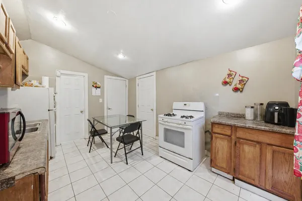 a kitchen with cabinets and chairs