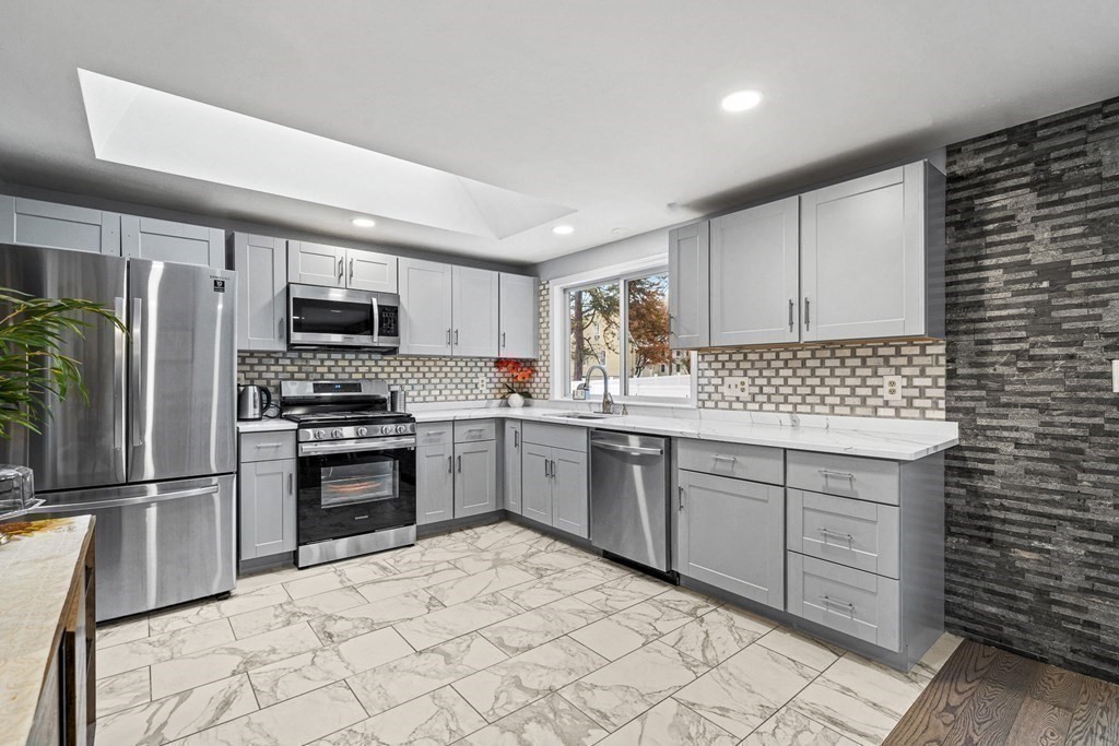 28 Sycamore Road Methuen, MA 01844 - Photo 13 of 35 a kitchen with granite countertop a refrigerator sink and microwave
