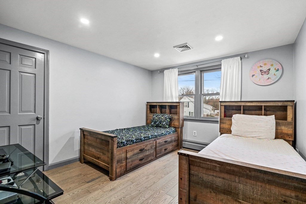 28 Sycamore Road Methuen, MA 01844 - Photo 14 of 35 a bedroom with a bed and a table in it