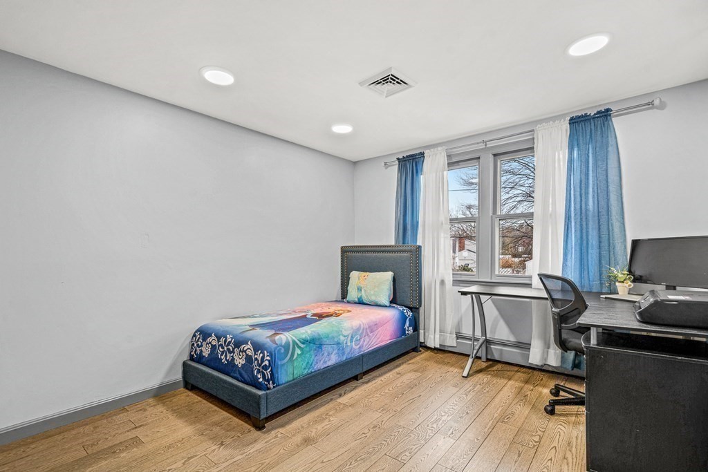 28 Sycamore Road Methuen, MA 01844 - Photo 17 of 35 a bedroom with a bed and wooden floor