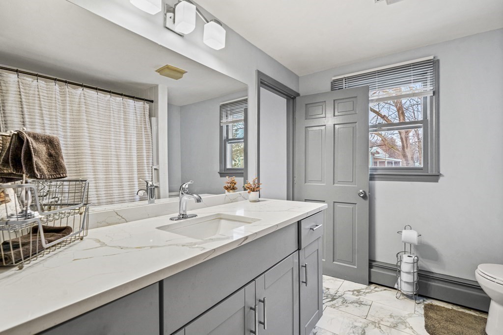 28 Sycamore Road Methuen, MA 01844 - Photo 21 of 35 a bathroom with a sink double vanity and a toilet
