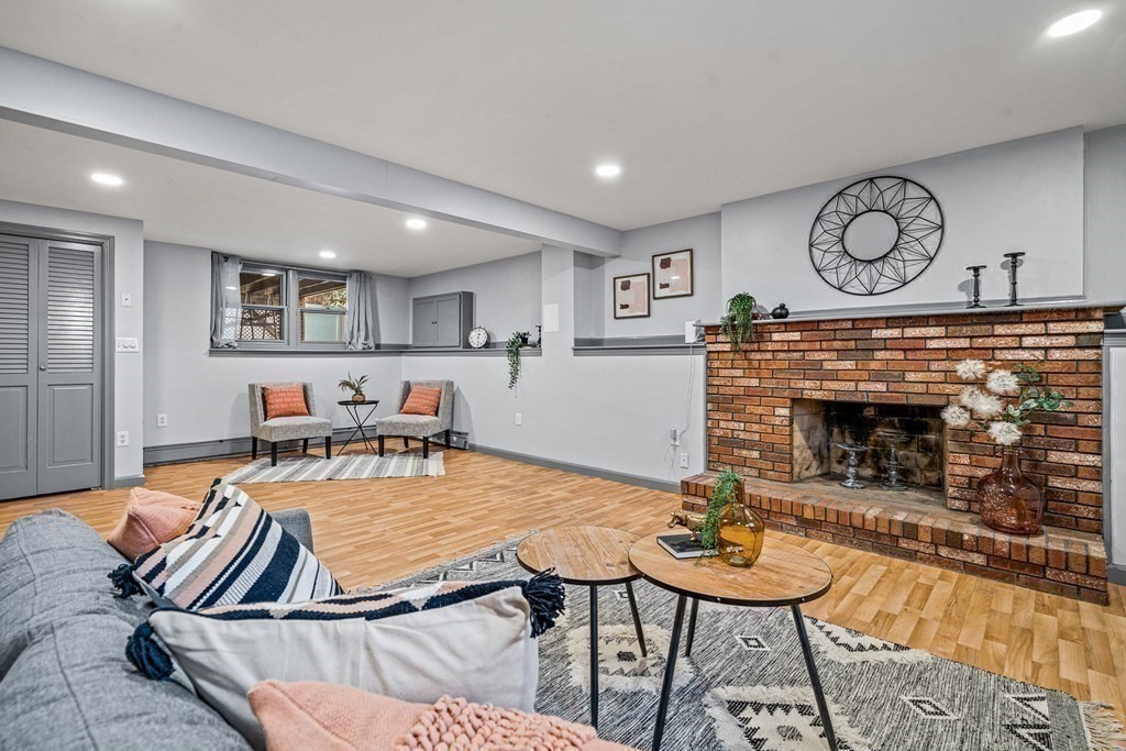 28 Sycamore Road Methuen, MA 01844 - Photo 25 of 35 a living room with furniture a clock and a fireplace