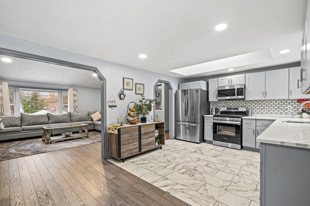 28 Sycamore Road Methuen, MA 01844 - Photo 9 of 35 a large kitchen with cabinets wooden floor and stainless steel appliances