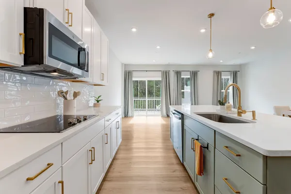 a kitchen with stainless steel appliances a sink stove and cabinets