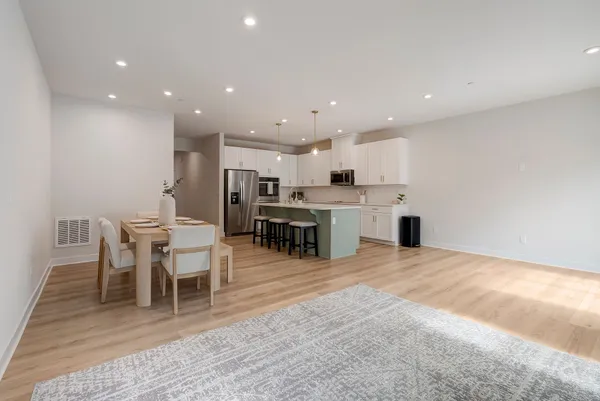 a large white kitchen with a table and chairs
