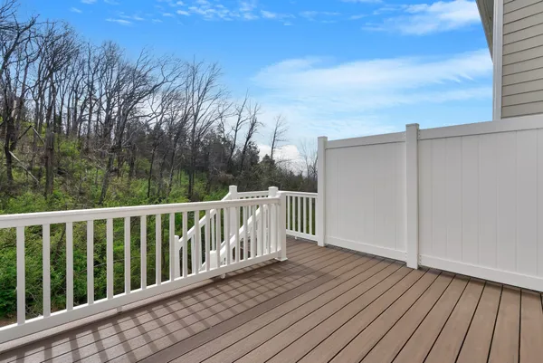 a balcony with wooden floor and fence