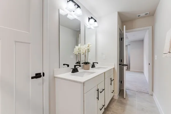a bathroom with a double vanity sink mirror and