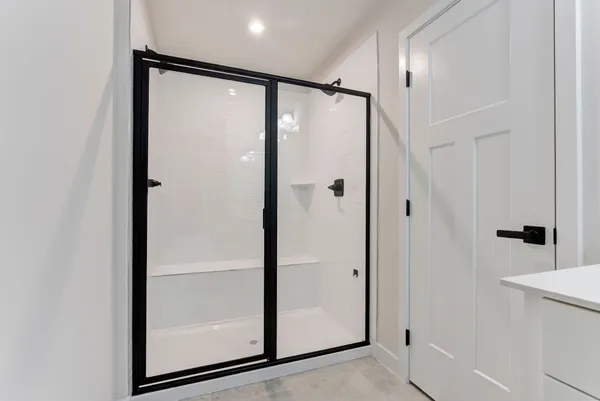 a bathroom with a glass shower door