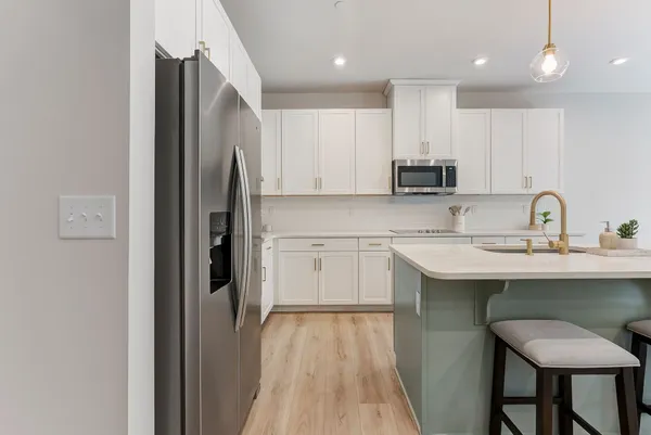 a kitchen with a sink stainless steel appliances and cabinets