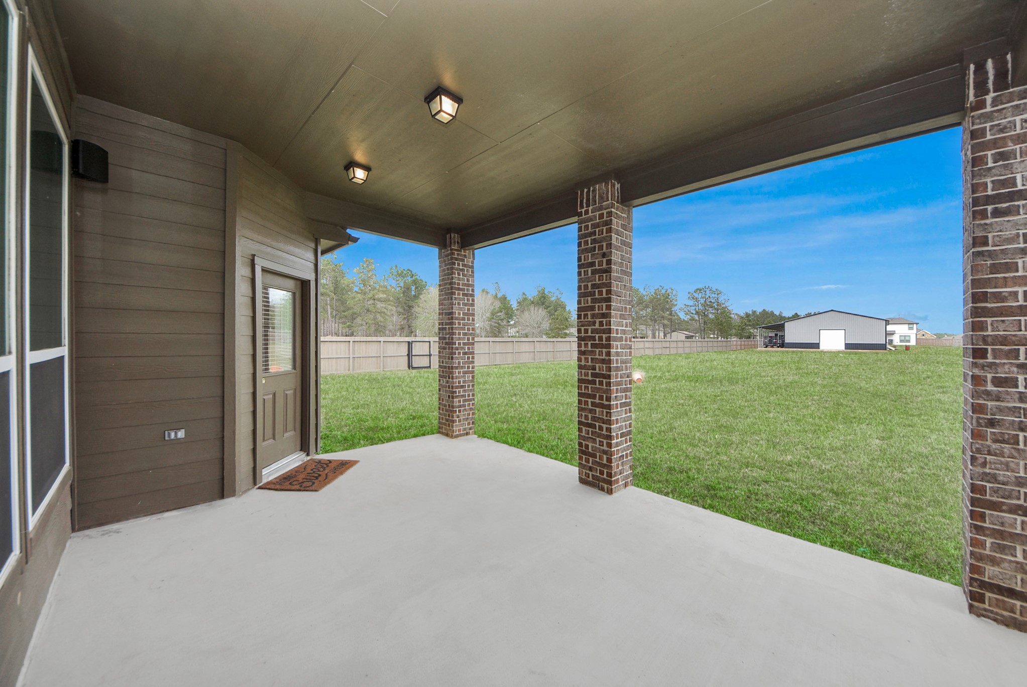 16735 Rockwall Street Conroe, TX 77303 - Photo 29 of 37 At the back of the home, a covered patio provides a comfortable outdoor retreat ideal for relaxing or hosting gatherings with family and friends.