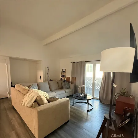 a living room with furniture and a lamp