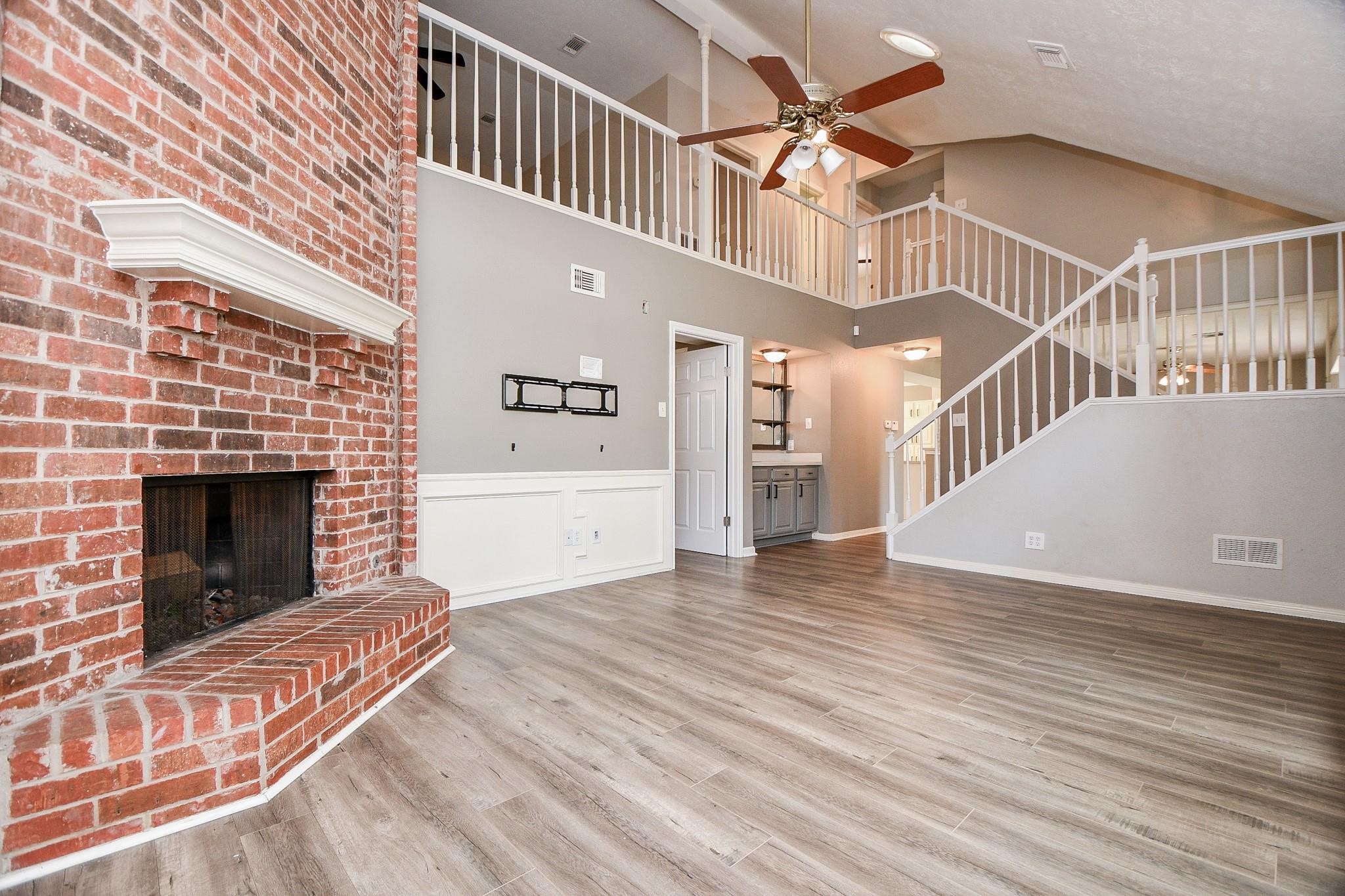 2331 Wren Meadow Road Richmond, TX 77406 - Photo 6 of 37 Another view of the spacious living space! High ceilings, neutral paint & floors, wainscoting, wet bar, fireplace, ceiling fan, bright & open!