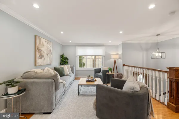 a living room with furniture rug and window