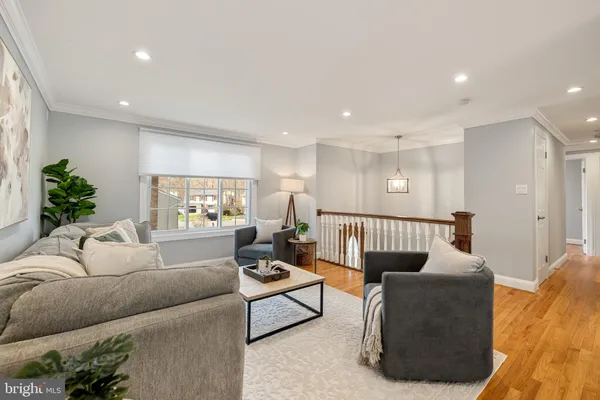 a living room with furniture window and wooden floor