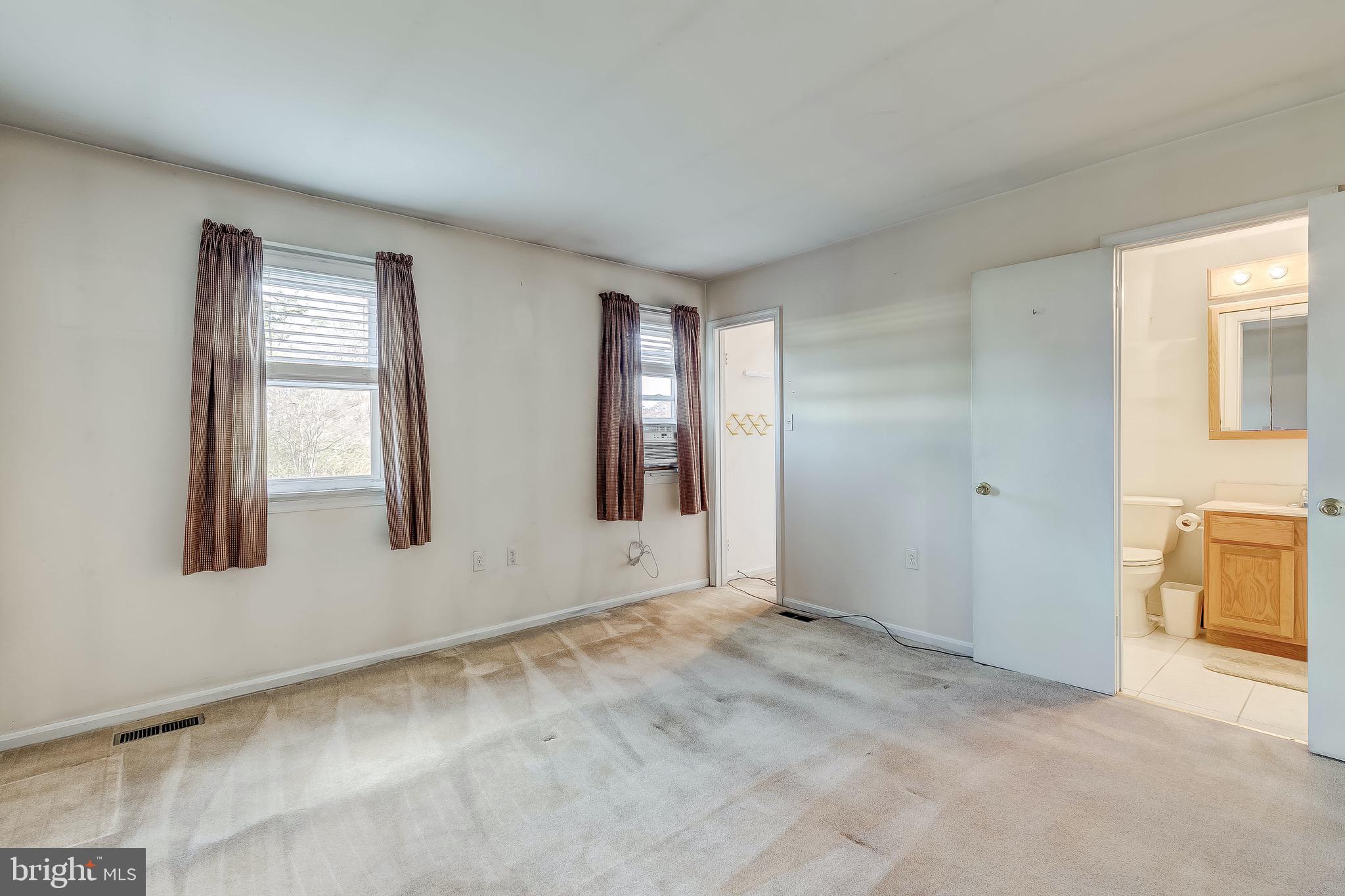 9326 Perglen Road Baltimore, MD 21236 - Photo 39 of 55 a view of an empty room with window and kitchen area