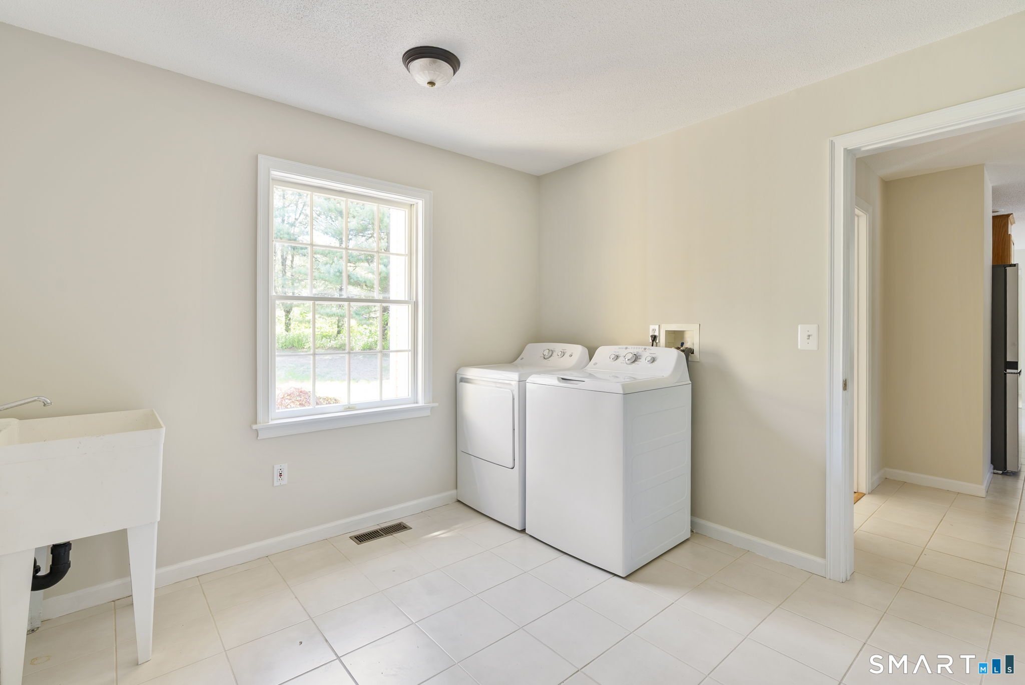 555 Waterville Road Avon, CT 06001 - Photo 28 of 40 a utility room with a window dryer and washer
