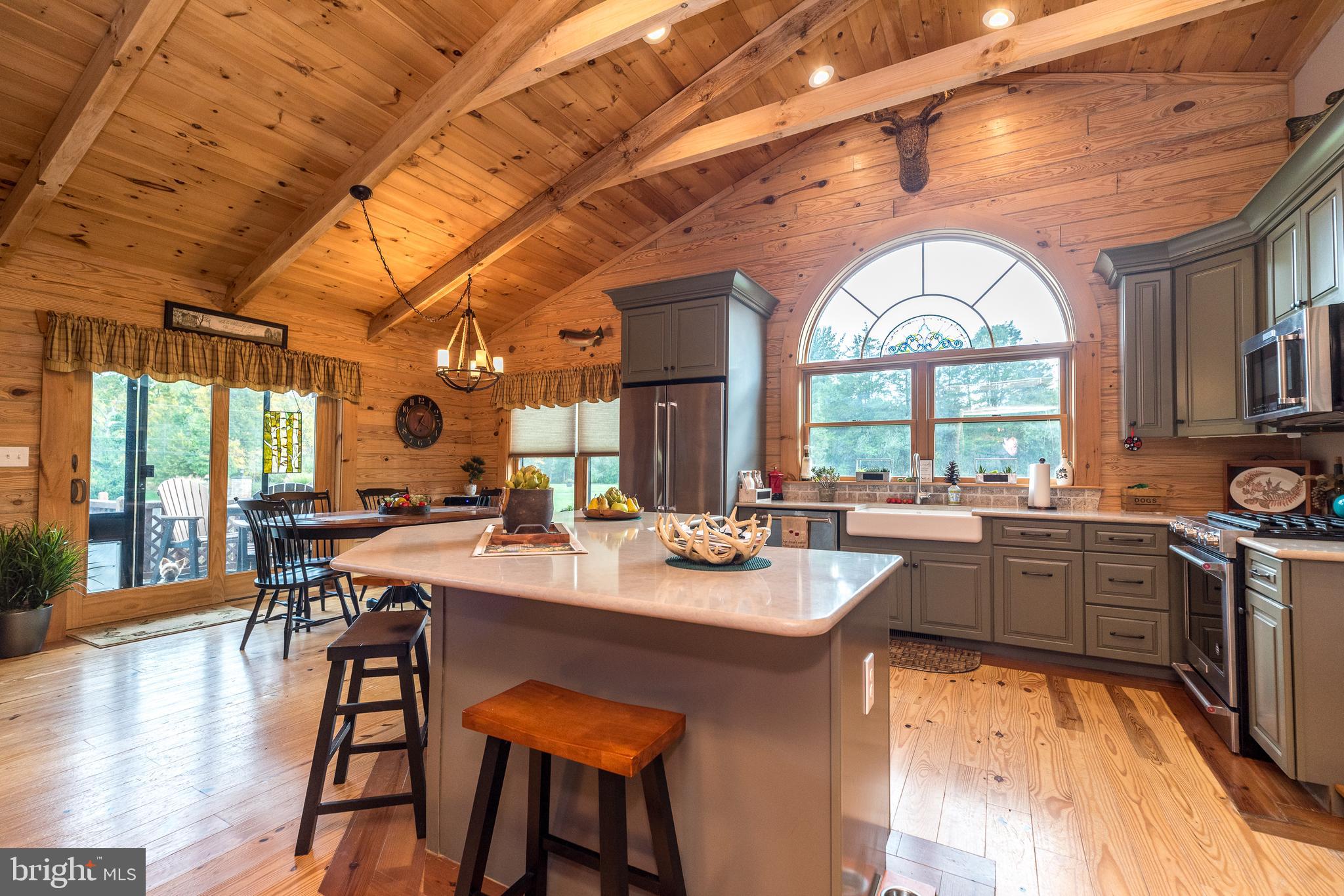 7223 Ferry Road New Hope, PA 18938 - Photo 25 of 87 a dining hall with stainless steel appliances granite countertop a stove a sink dishwasher and a dining table with wooden floor