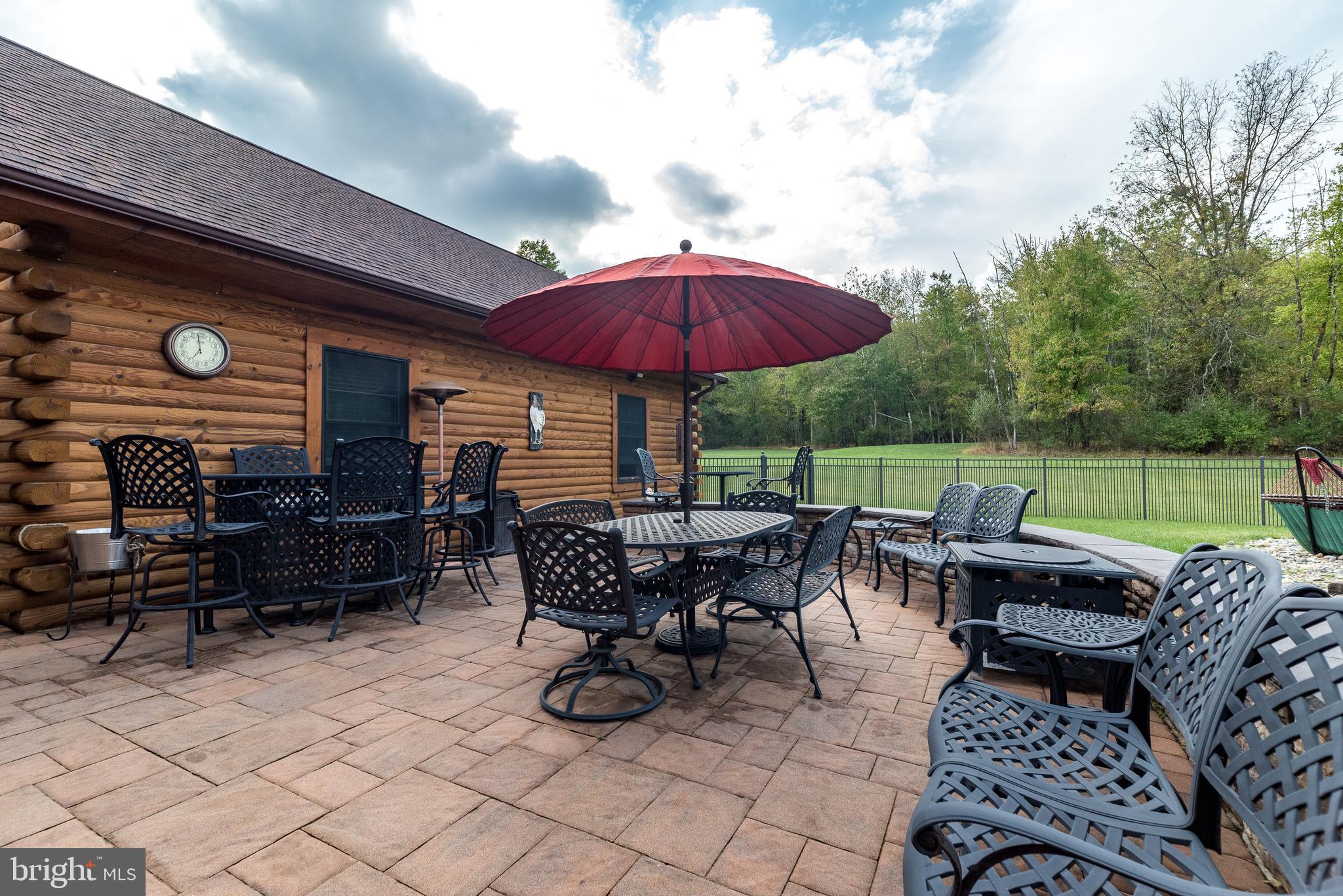 7223 Ferry Road New Hope, PA 18938 - Photo 45 of 87 a view of a patio with a dining table and chairs under an umbrella