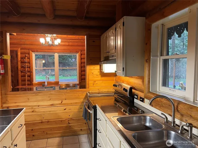a kitchen with granite countertop a sink and a window