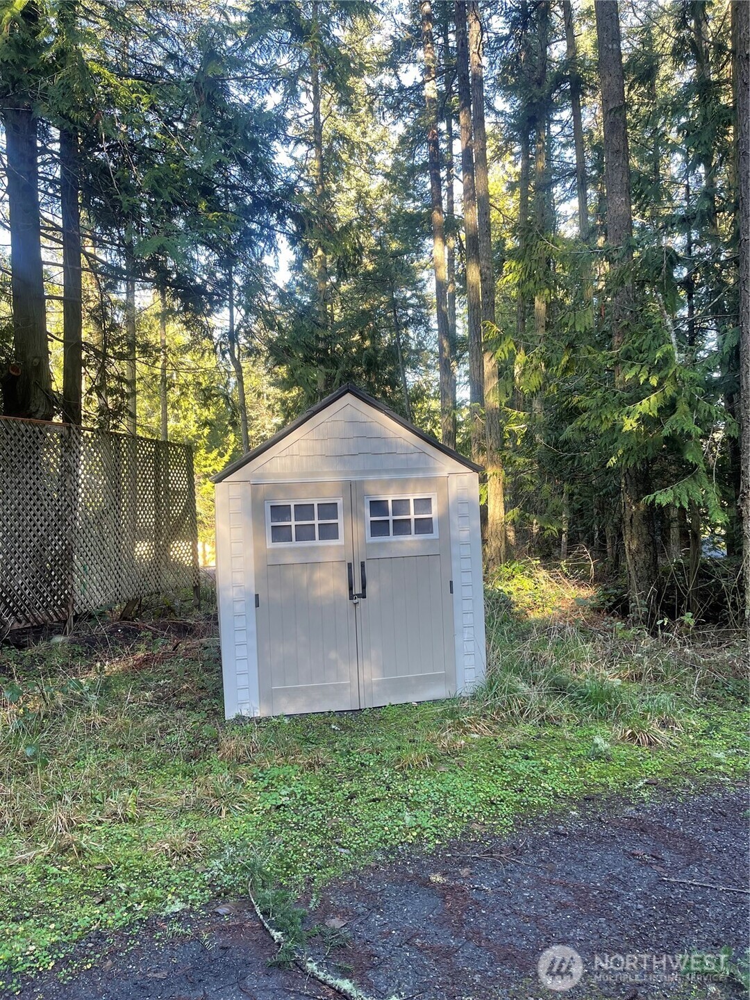 276 Point Caution Drive Friday Harbor, WA 98250 - Photo 13 of 21 a view of a wooden house with a yard and large tree