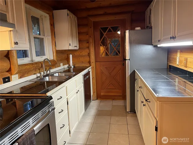 a kitchen with a sink stove and cabinets