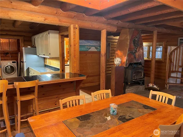 a view of a kitchen with a dining table and chairs