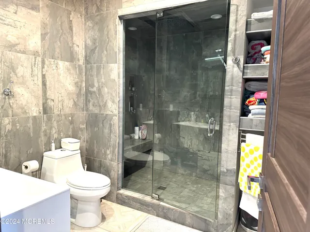 a bathroom with a toilet and a shower
