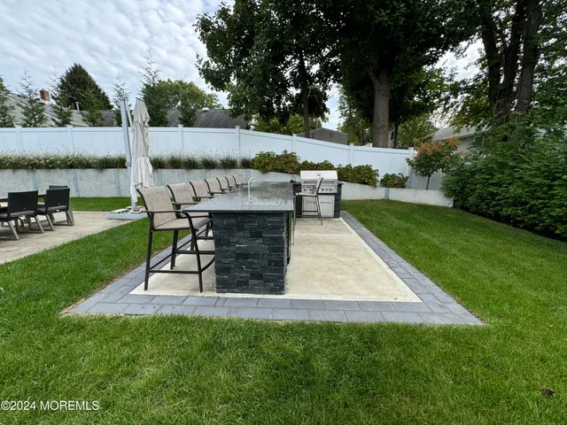 a view of a backyard with sitting area