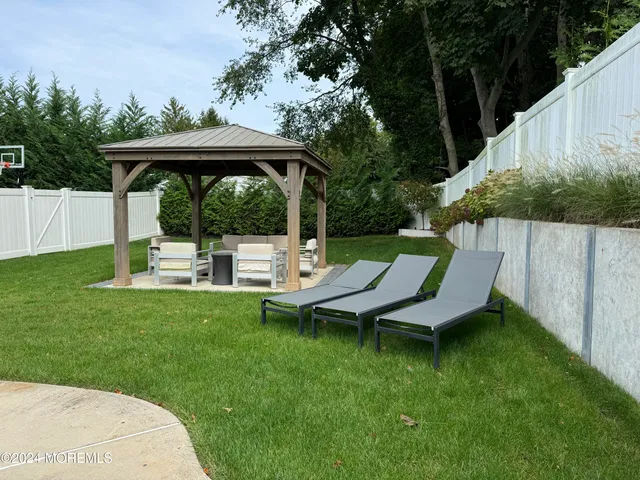 a view of a deck with a table chairs and a yard