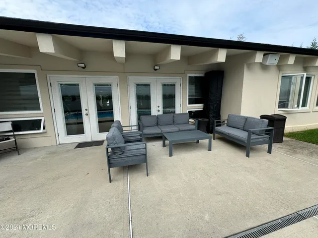 a outdoor living space with furniture and a fireplace