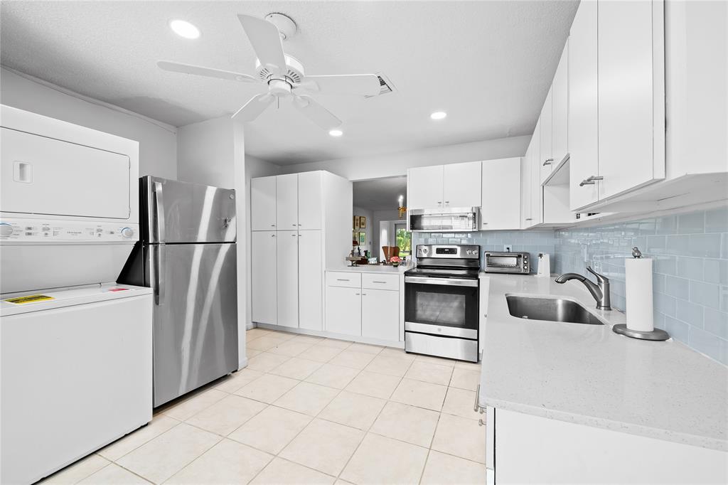 a kitchen with a refrigerator a sink and a stove