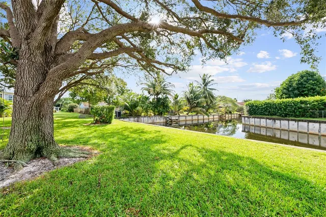 a view of backyard with swimming pool and green space
