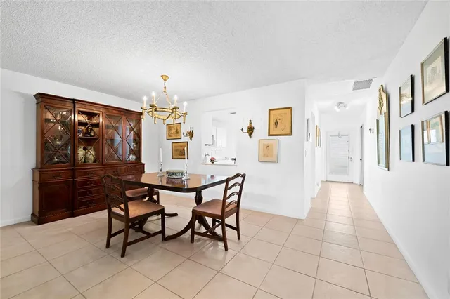 a view of a dining room with furniture and chandelier