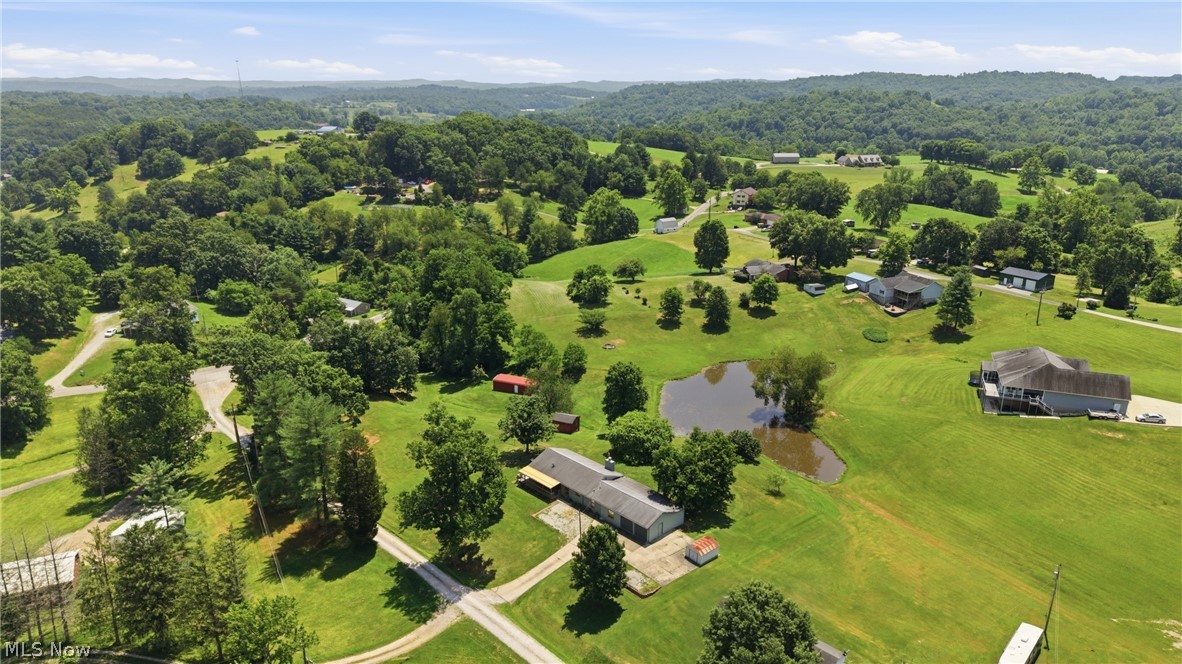 89 Dagg Road Parkersburg, WV 26101 - Photo 5 of 45 Expansive property featuring a pond, established trees, and multiple structures