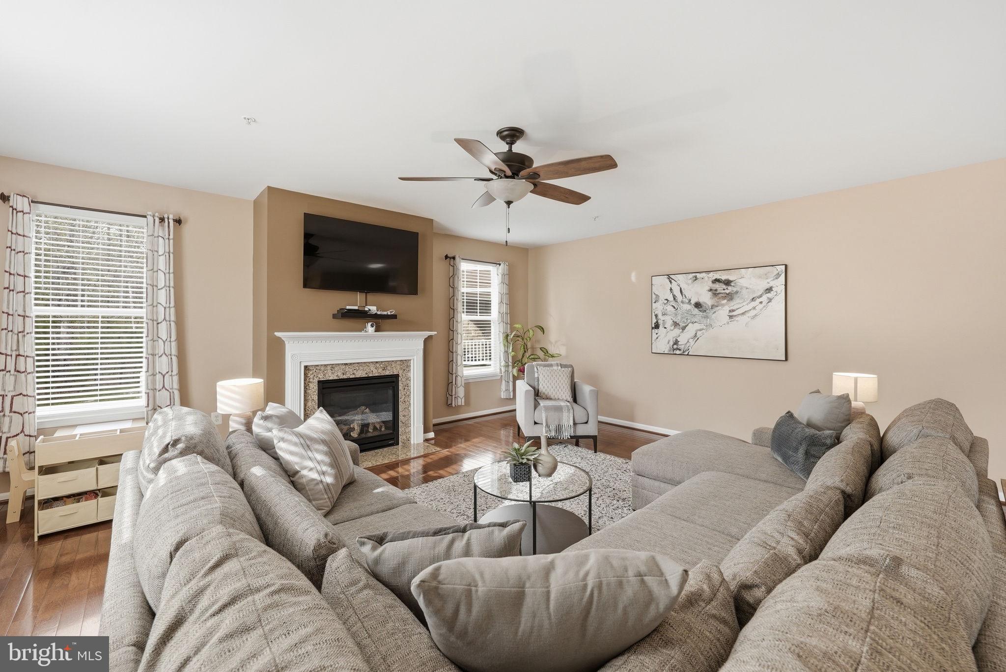 6900 Lenape Court Brandywine, MD 20613 - Photo 12 of 43 a living room with furniture a flat screen tv and a fireplace