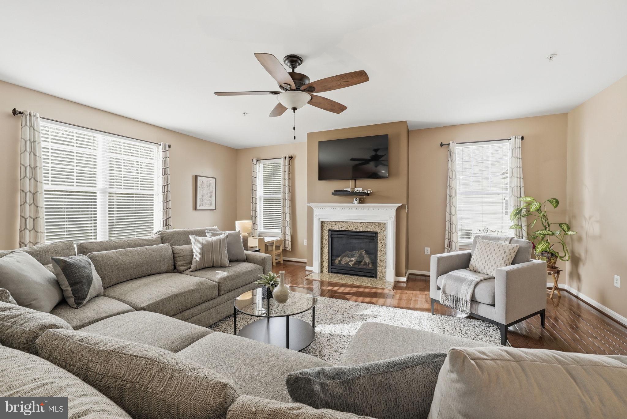 6900 Lenape Court Brandywine, MD 20613 - Photo 13 of 43 a living room with furniture a fireplace and a flat screen tv