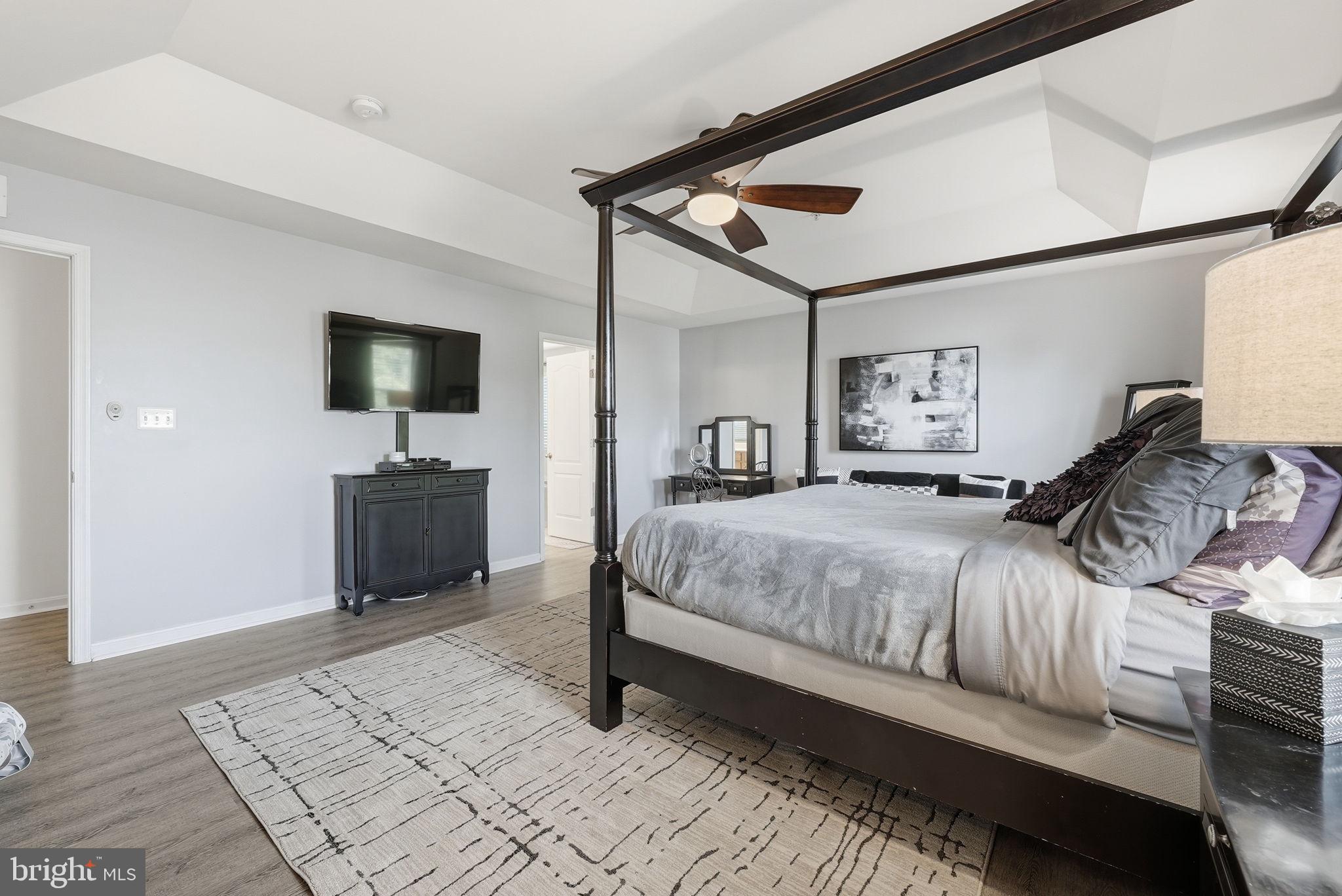 6900 Lenape Court Brandywine, MD 20613 - Photo 20 of 43 a spacious bedroom with a bed and a flat screen tv