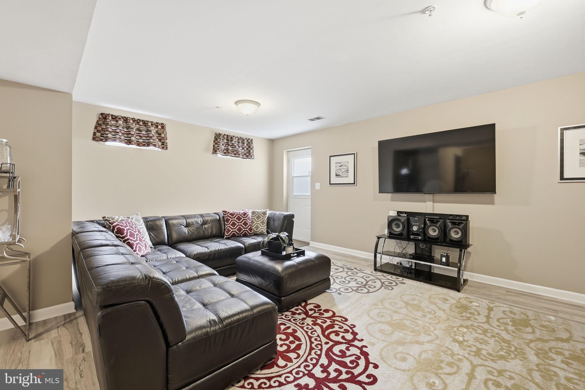 6900 Lenape Court Brandywine, MD 20613 - Photo 34 of 43 a living room with furniture and a flat screen tv