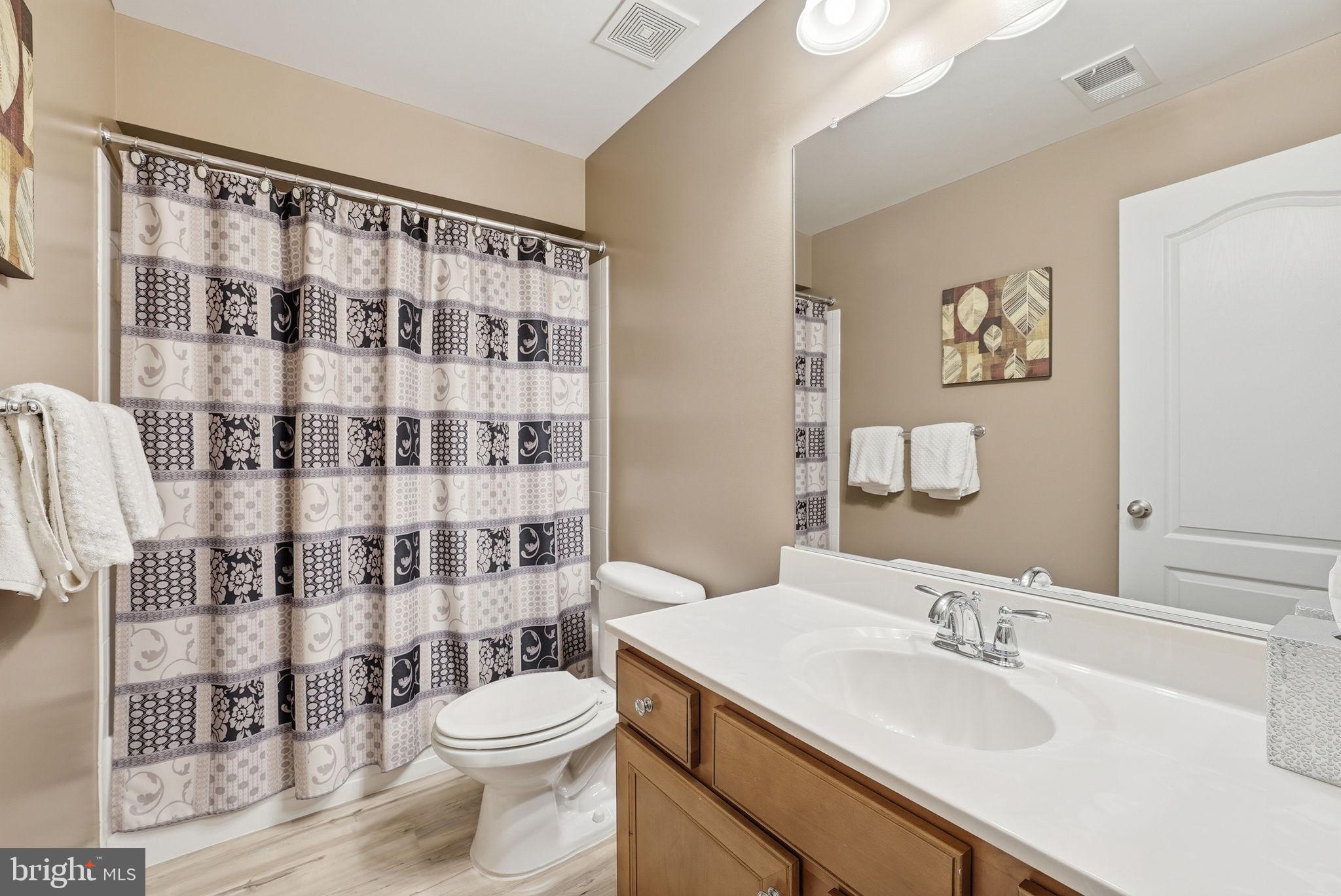 6900 Lenape Court Brandywine, MD 20613 - Photo 37 of 43 a bathroom with a sink a toilet and a shower