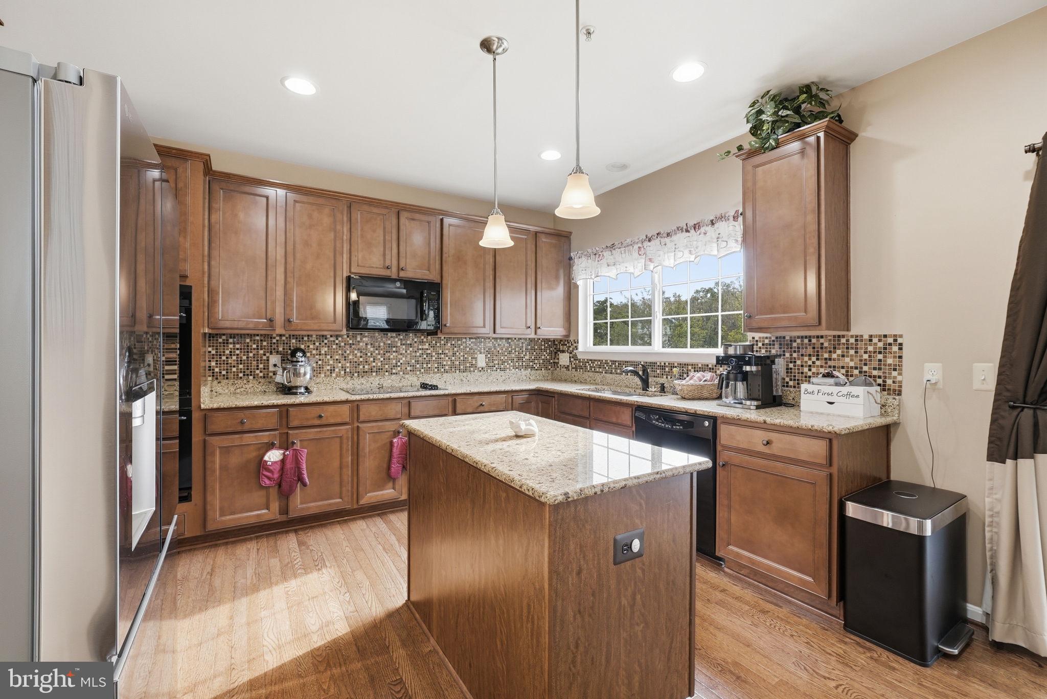 6900 Lenape Court Brandywine, MD 20613 - Photo 6 of 43 a kitchen with a sink stove and wooden cabinets