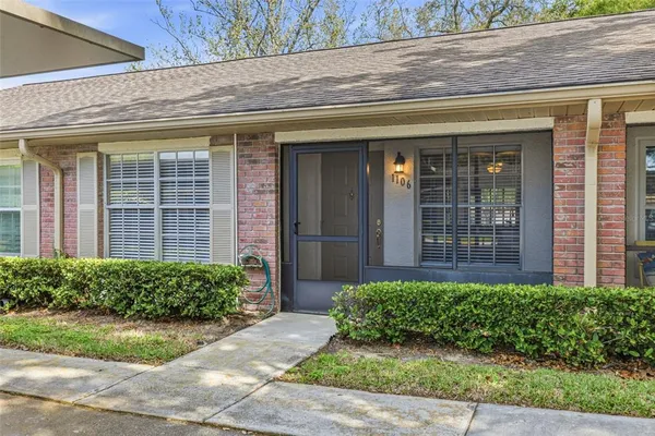 a front view of a brick house with a yard