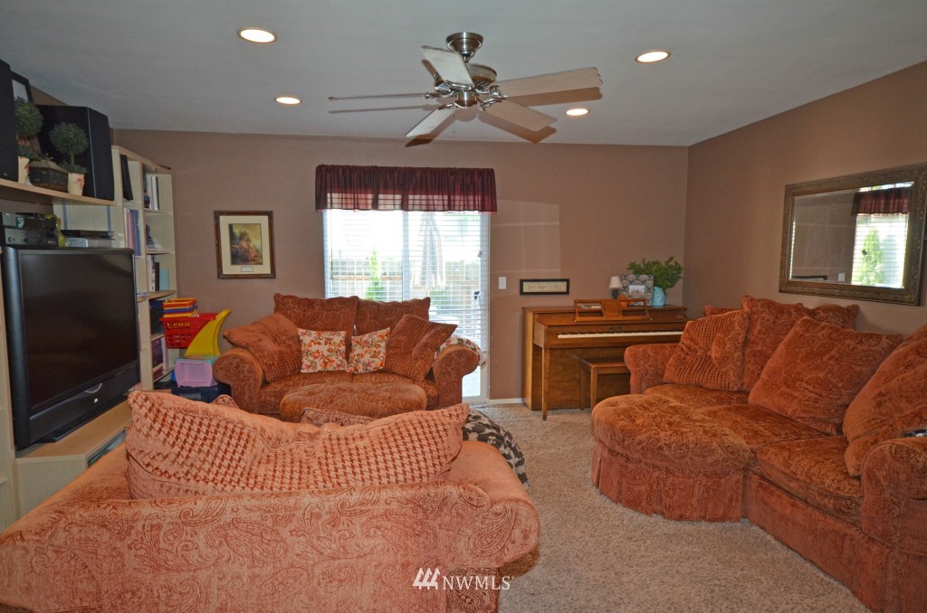 2608 165th Place Southeast Bothell, WA 98012 - Photo 2 of 13 a living room with furniture a ceiling fan and a window