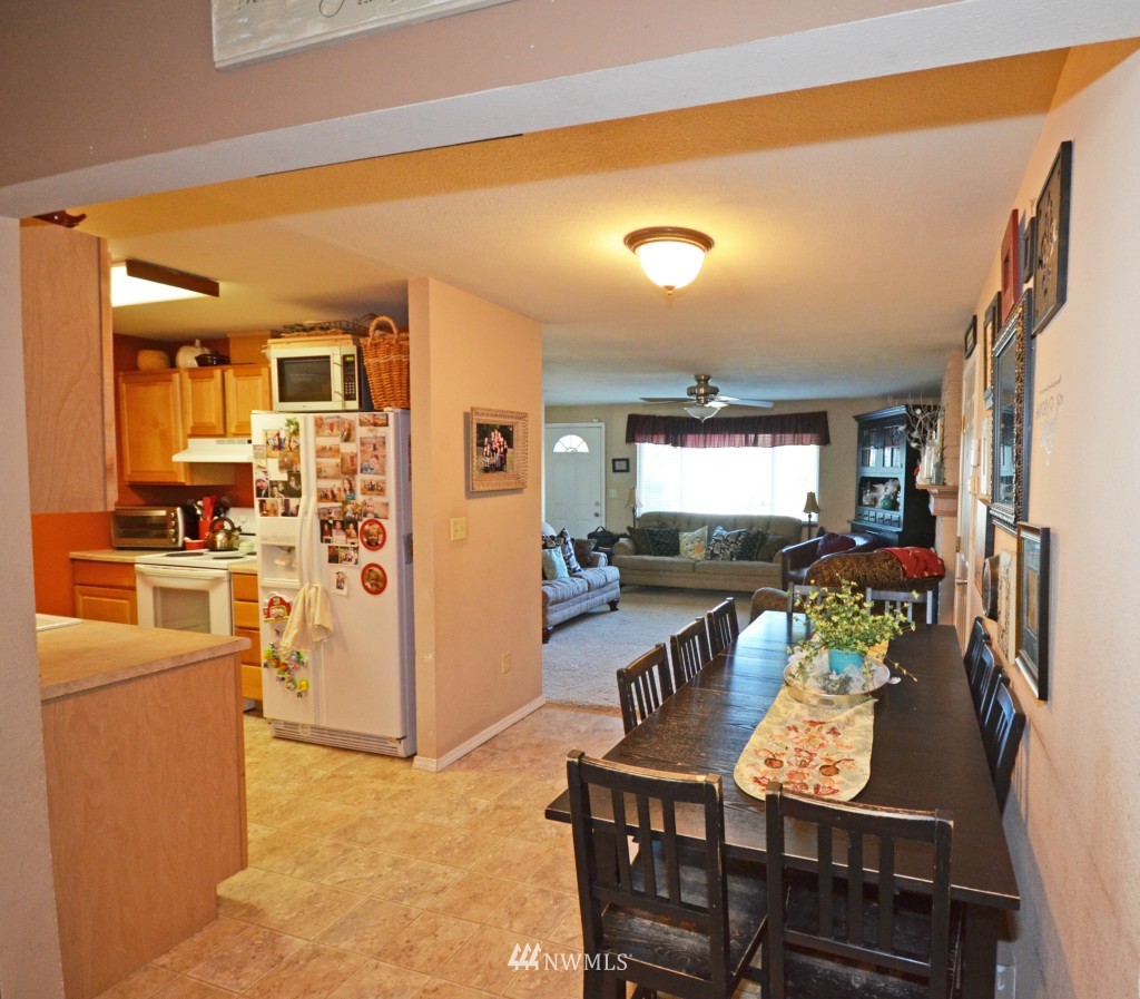 2608 165th Place Southeast Bothell, WA 98012 - Photo 4 of 13 a view of a dining room with furniture a kitchen and chandelier