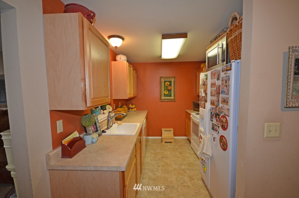 2608 165th Place Southeast Bothell, WA 98012 - Photo 5 of 13 a bathroom with a sink a mirror and shower