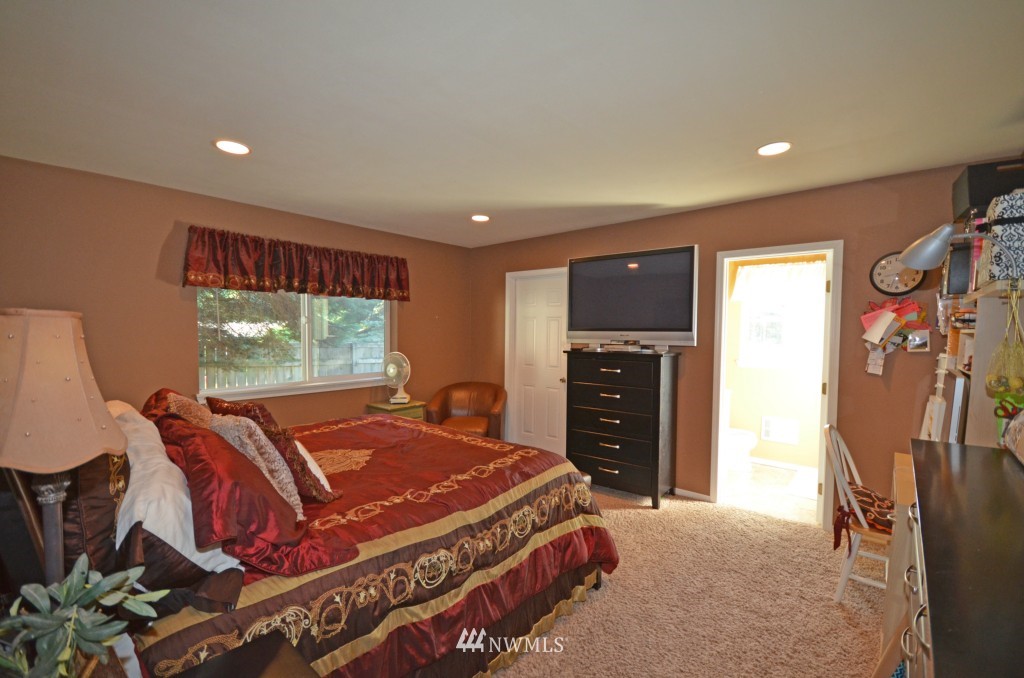 2608 165th Place Southeast Bothell, WA 98012 - Photo 6 of 13 a bed room with a bed and a television