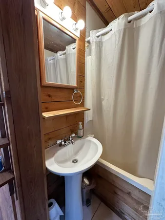 a bathroom with a sink a mirror a vanity and a toilet