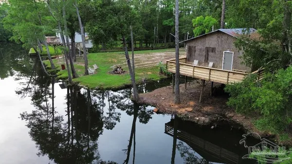 a view of a chair and table in the patio next to a yard