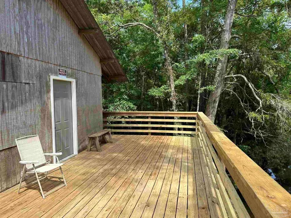 a view of balcony with wooden floor and bench