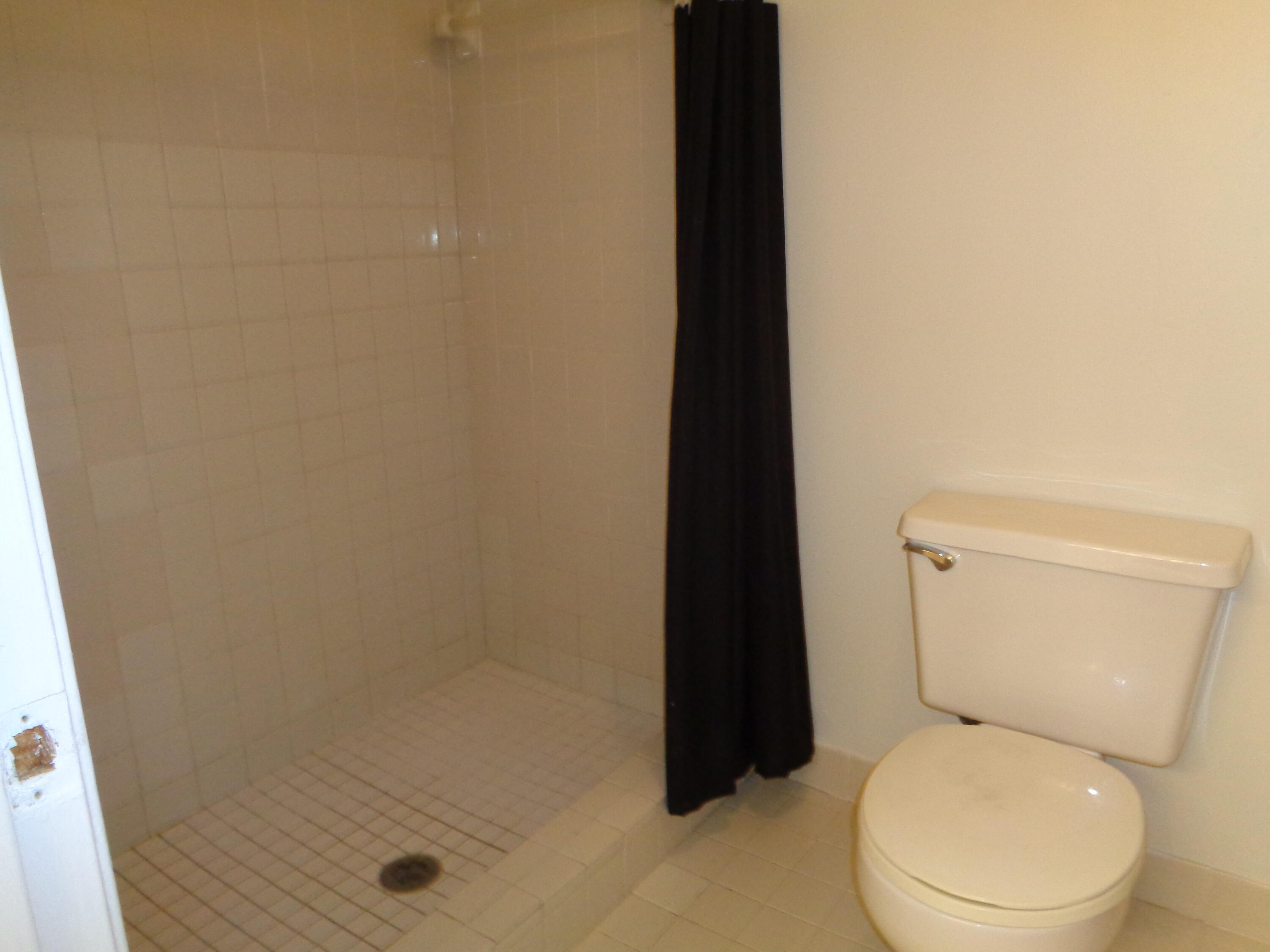 301 Olivewood Place, Unit O227 Boca Raton, FL 33431 - Photo 11 of 20 a white toilet sitting next to a shower